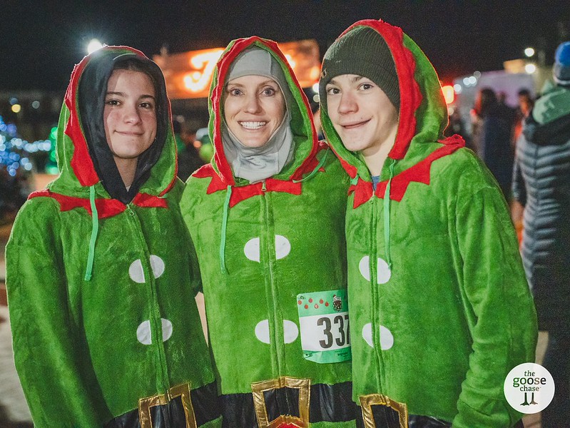 Three participants in green and red elf costumes at a past Jingle event