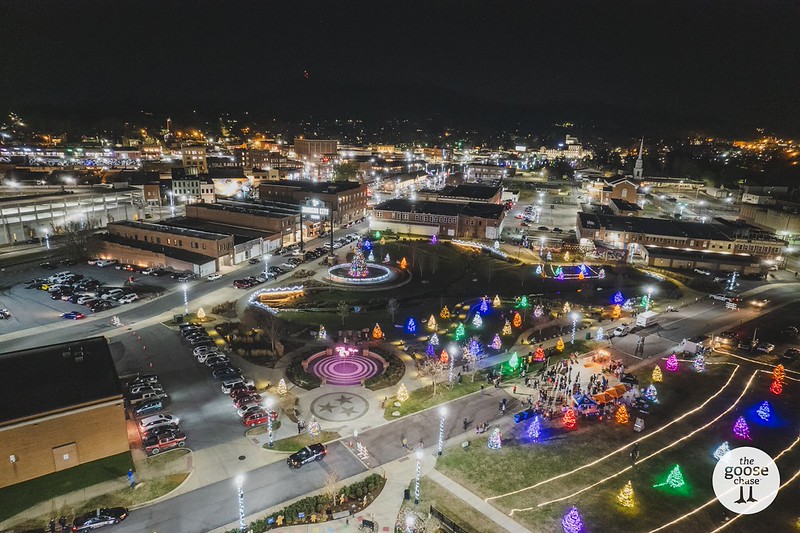 Aerial nighttime view of Johnson City with illuminated Christmas trees during a past Jingle event